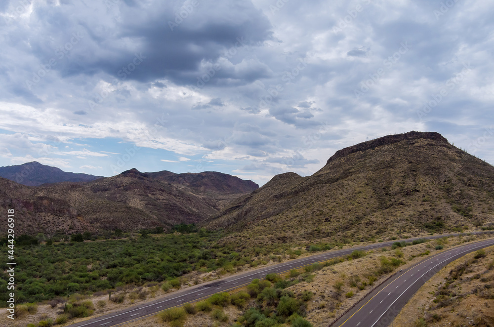 Aerial view adventure traveling desert road of the asphalt highway across the arid desert Arizona mountains