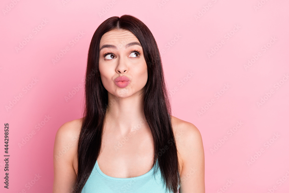 Photo of beauty flirty brown long hairdo lady look empty space blow kiss wear blue top isolated on pastel pink color background