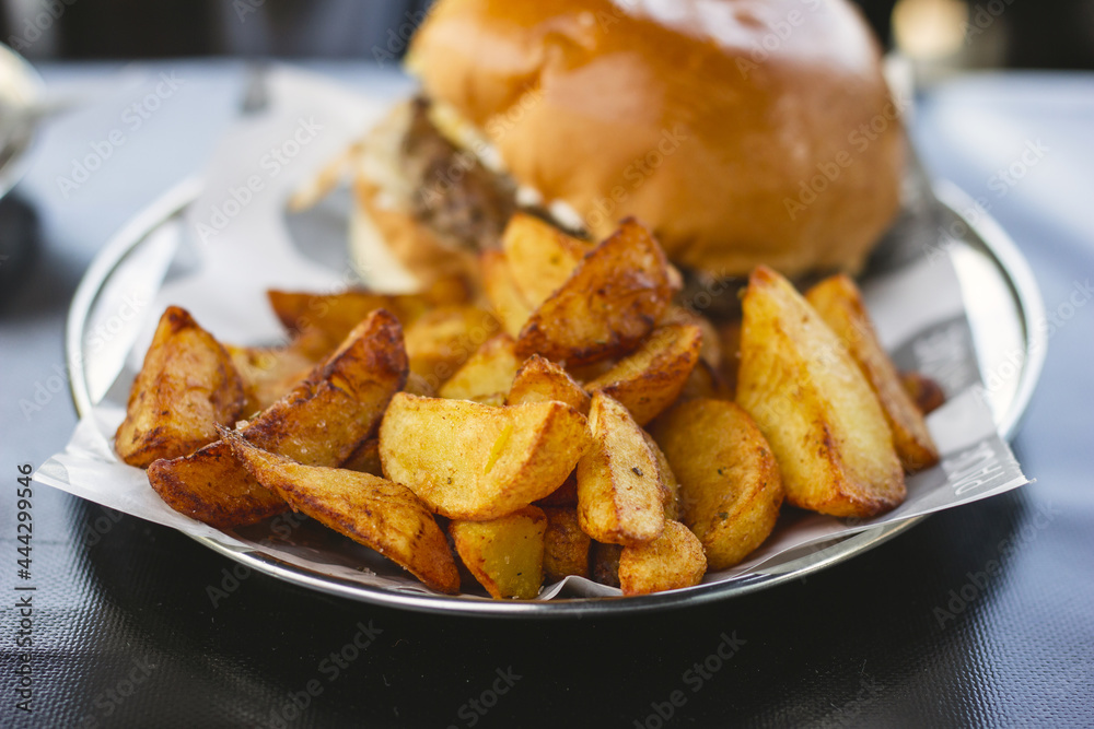 Hamburger with provolone, radicchio, bacon and delicious french fries Hamburger with provolone, radicchio, bacon and delicious french fries