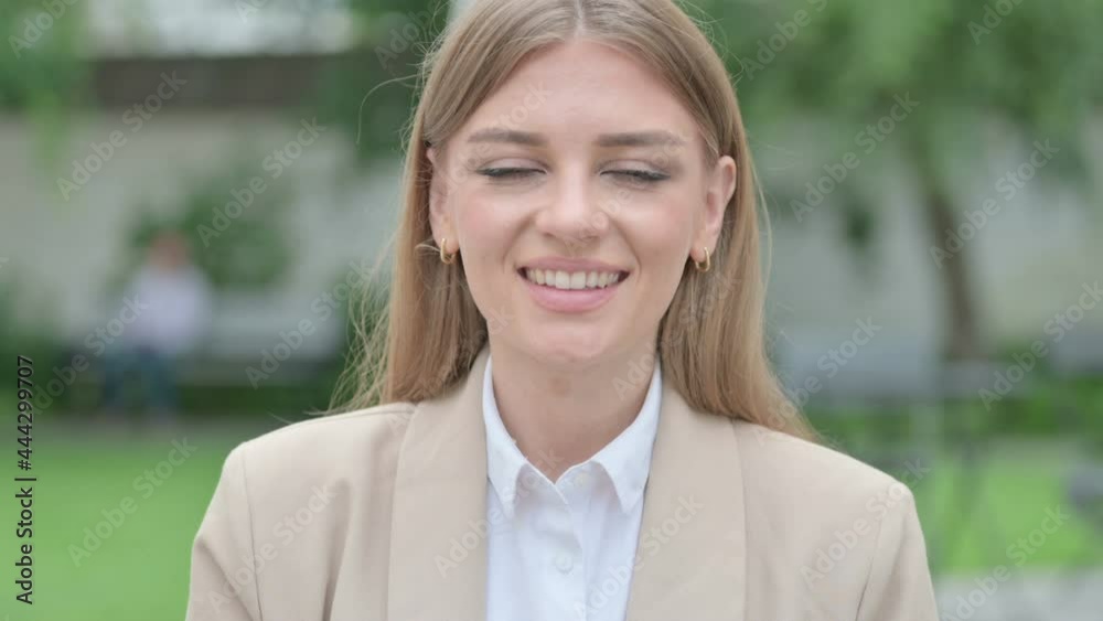 Outdoor Portrait of Young Businesswoman Pointing and Inviting Outdoor Portrait of Young Businesswoman Pointing and Inviting