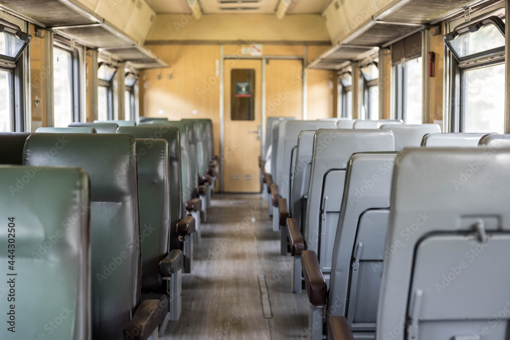 Interior of a passenger train with empty seats. An old train car from the inside. Russian Railways.