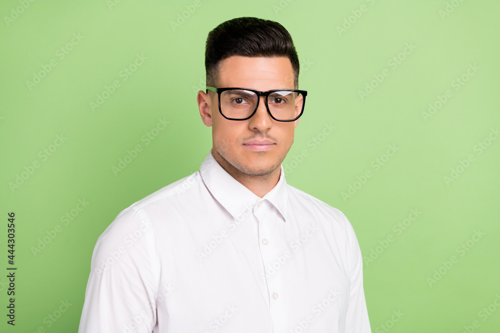 Photo of pretty confident young guy dressed white shirt glasses isolated green color background Photo of pretty confident young guy dressed white shirt glasses isolated green color background