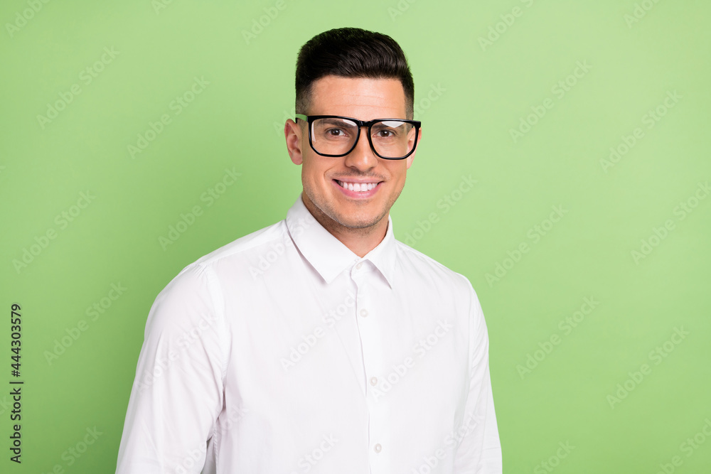Photo of cute charming young gentleman wear white shirt spectacles smiling isolated green color background Photo of cute charming young gentleman wear white shirt spectacles smiling isolated green color background