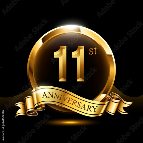11 years golden anniversary logo celebration with ring and ribbon.