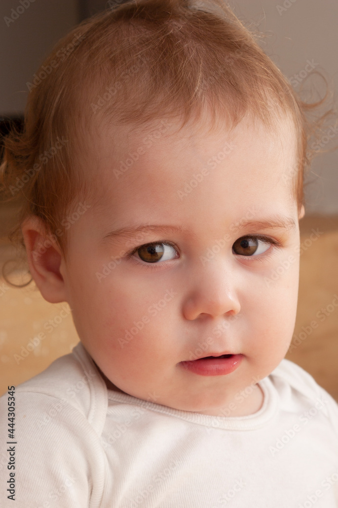 portrait of a blond baby looking at camera