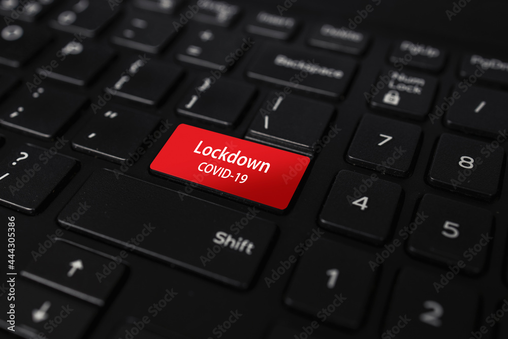lockdown covid-19 button. closeup black keyboard with soft-focus on the background lockdown covid-19 button. closeup black keyboard with soft-focus on the background