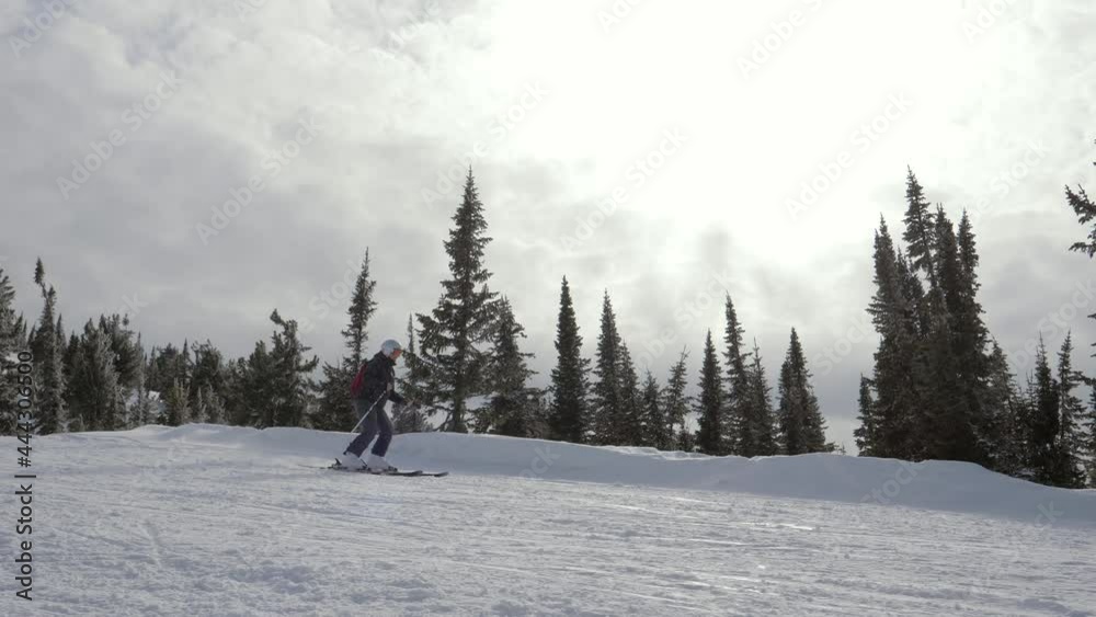 Skier Skiing On Ski Piste In Hills Mountains On Sunny Day At Winter In Motion Skier Skiing On Ski Piste In Hills Mountains On Sunny Day At Winter In Motion