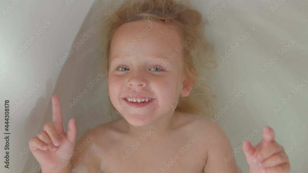 Happy kid enjoying the bath