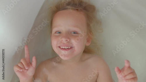 Happy kid enjoying the bath photo