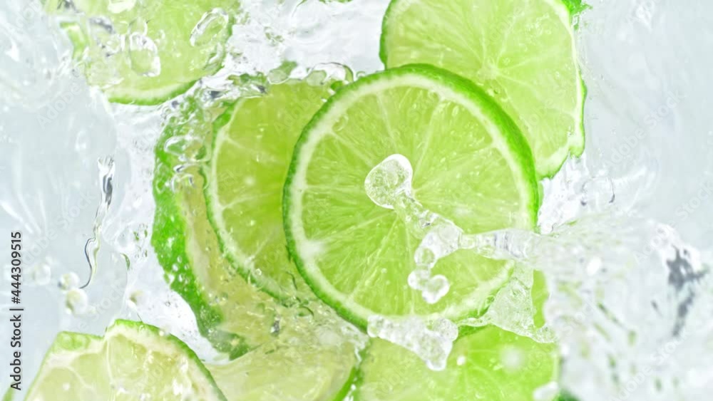 Super Slow Motion Shot of Lime Slices Falling Into Water Whirl at 1000 fps. Super Slow Motion Shot of Lime Slices Falling Into Water Whirl at 1000 fps.