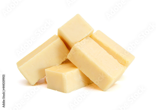 Cubes of cheddar cheese isolated on white  photo