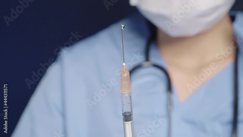 Female doctor preparing coronavirus vaccine for public injection service