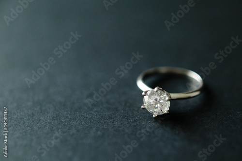 Diamond ring on black texture background