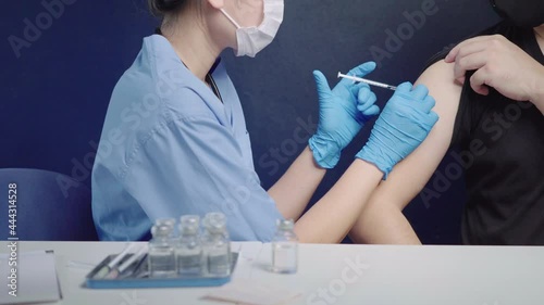 Doctors vaccinate people against COVID-19 who received treatment