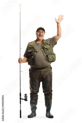 Full length portrait of a fisherman with a fishing rod standing and waving