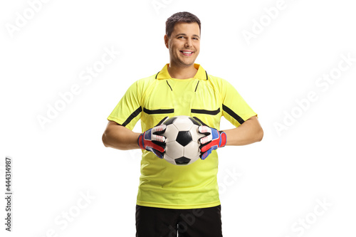 Goalkeeper holding a ball and smiling