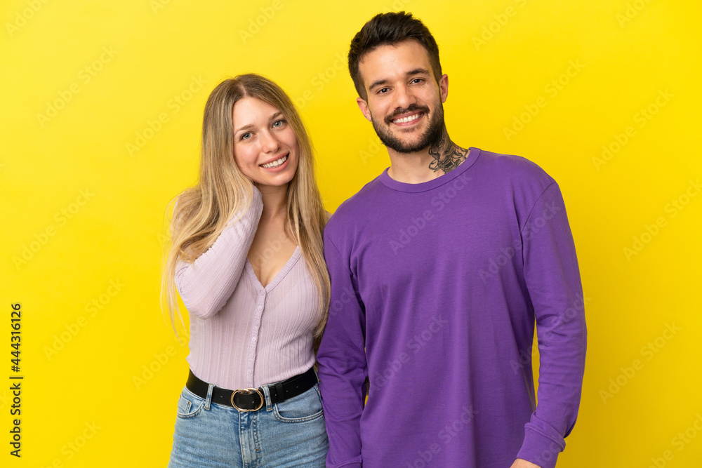 Young couple over isolated yellow background happy and laughing Young couple over isolated yellow background happy and laughing