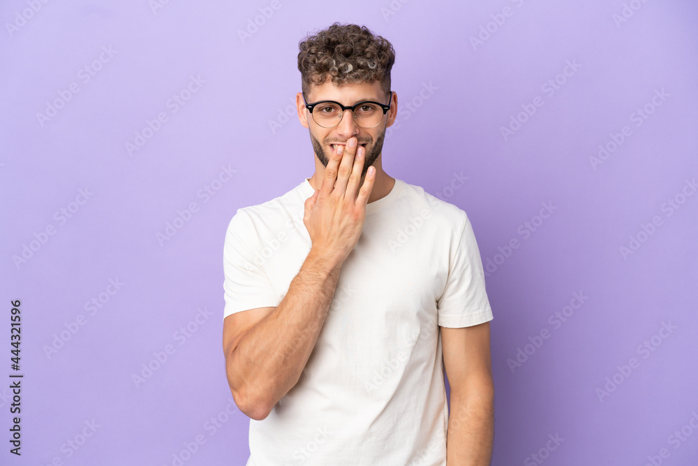 Delivery caucasian man isolated on purple background happy and smiling covering mouth with hand Delivery caucasian man isolated on purple background happy and smiling covering mouth with hand