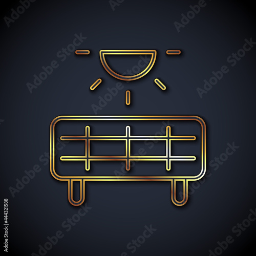 Gold line Solar energy panel icon isolated on black background. Vector