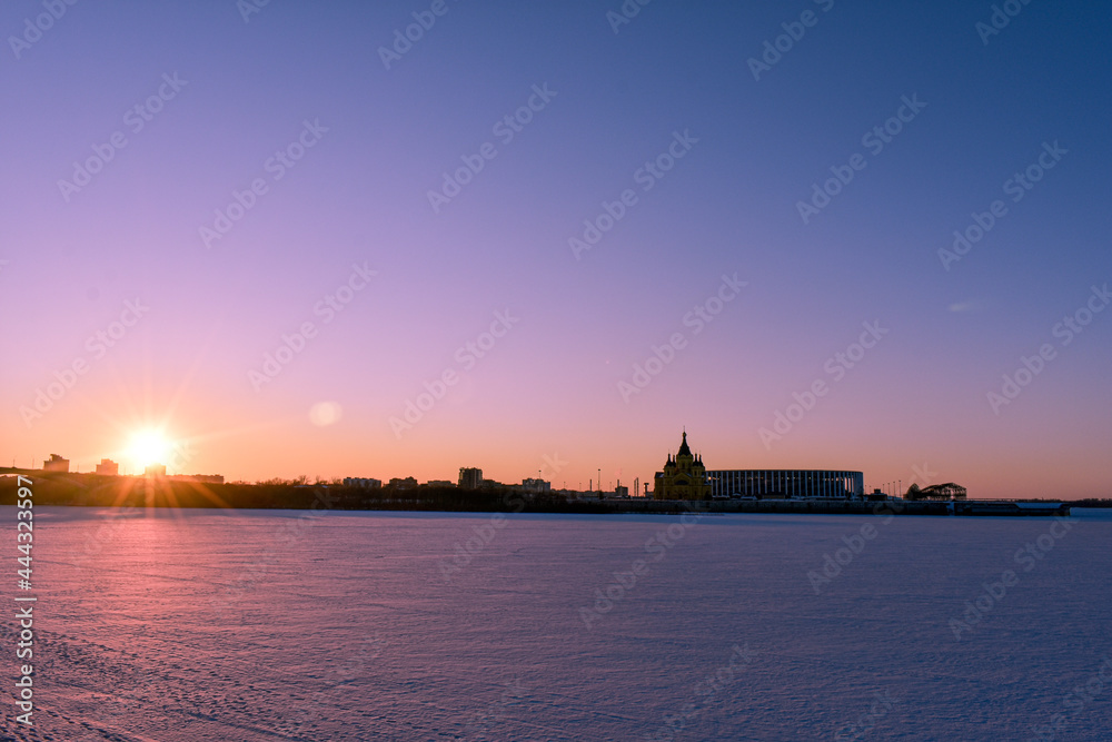 winter sunset on the city's waterfront - obrazy, fototapety, plakaty 