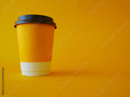 A disposable cup with a yellow background is located on the left side of the frame.