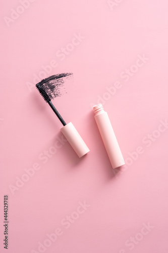 Flat lay mascara with stroke on pink background. photo