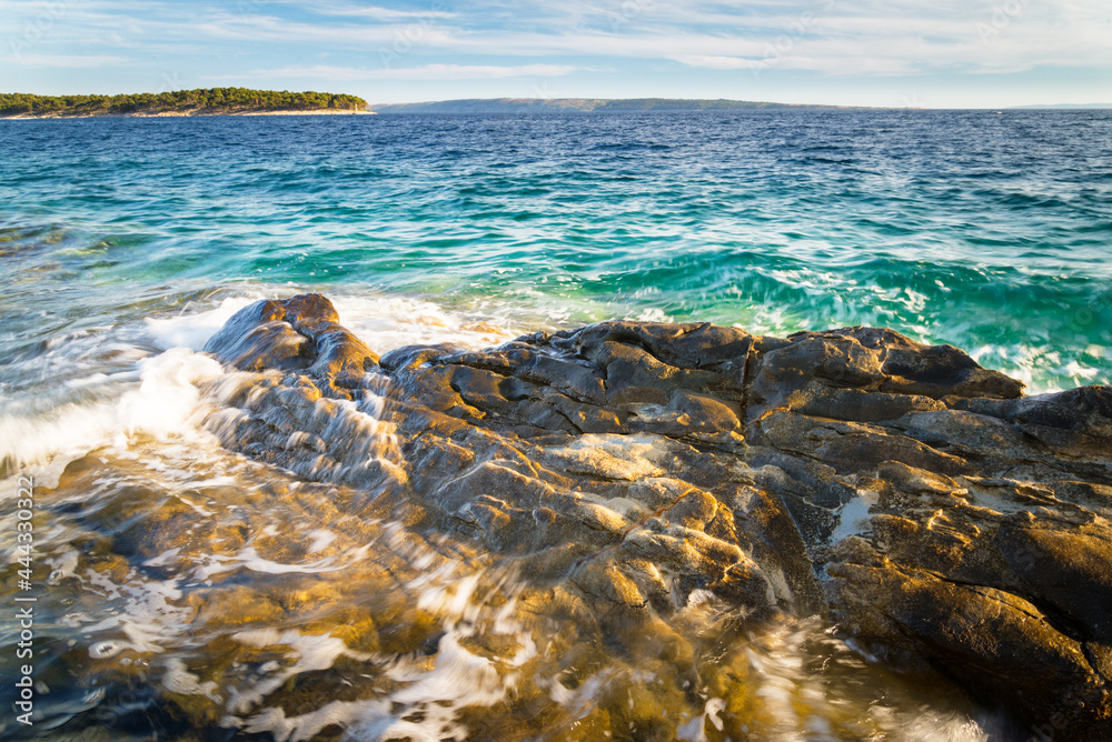Waves splashing on the rocks of the shore adriatic sea