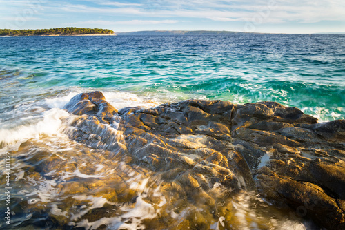 Waves splashing on the rocks of the shore adriatic sea