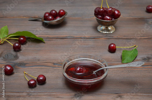 still life with cherry jam and berries on a dark wooden background