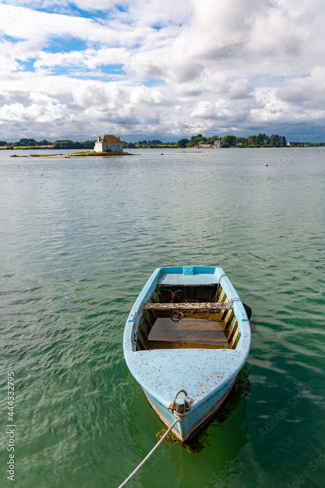The house of Saint-Cado in Brittany, on the Etel river, with a blue row boat
The house of Saint-Cado in Brittany, on the Etel river, with a blue row boat
