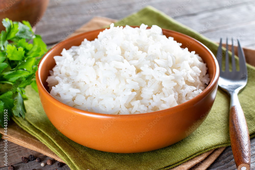 Cooked rice in a bowl on an wooden table Cooked rice in a bowl on an wooden table