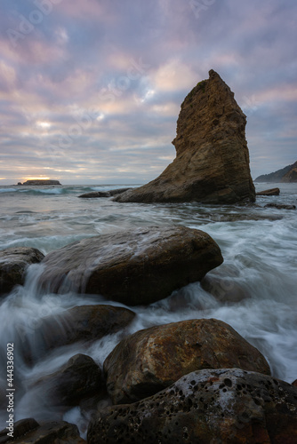 High tide waves approaching during sunset on the rugged and beautiful Oregon Coast