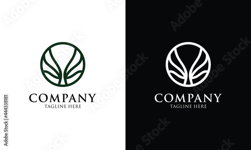 Negative space logo of a tree in a aqua colored circle. Character: calm, relaxed, modern, timeless, organic and natural. Suitable for organic food, make up, environmental, nature conservation, etc