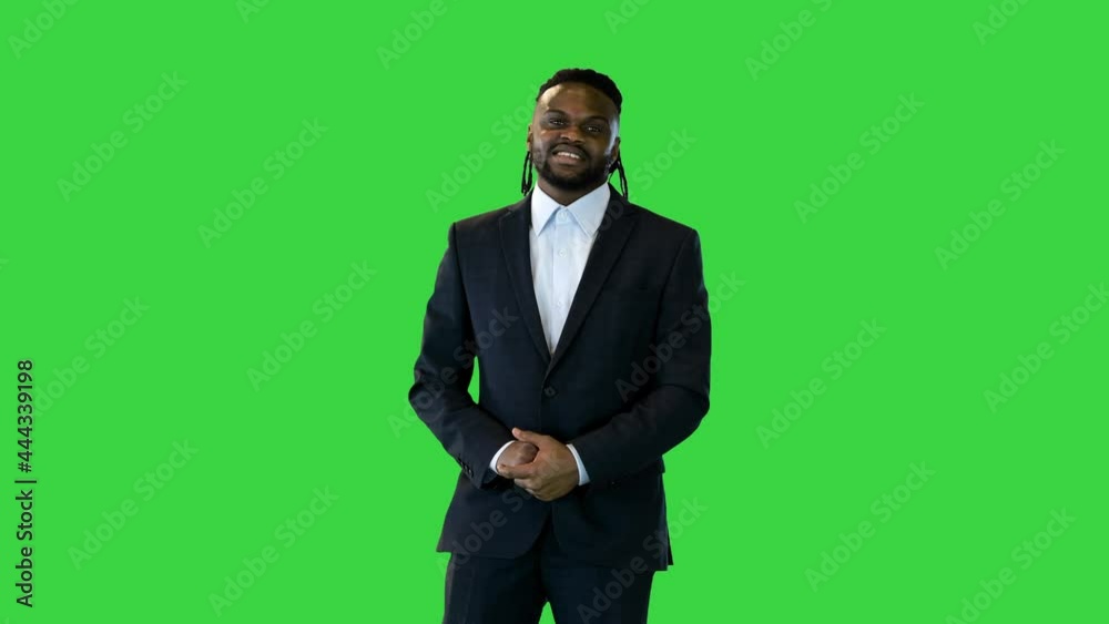 Black man in office suit telling something in front of camera on a Green Screen, Chroma Key. Black man in office suit telling something in front of camera on a Green Screen, Chroma Key.