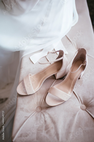 Beautiful wedding shoes. Gentle wedding picture. Pink wedding shoes with bride in the background. Modern wedding concept.