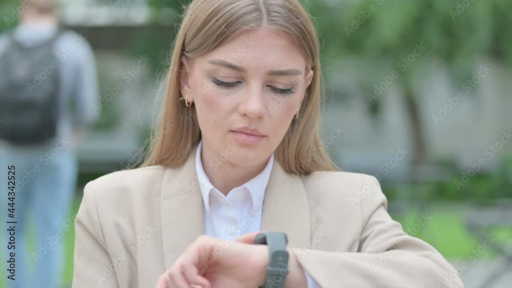 Outdoor Portrait of Young Businesswoman using Smart watch Outdoor Portrait of Young Businesswoman using Smart watch