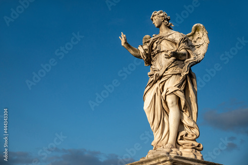 Beautiful detail of an Angel from the Bernini school, Castel Sant'Angelo, Vatican, from the Ponte degli Angeli over the Tiber, with a clear blue sky after a thunderstorm, Vatican, Rome, Italy.