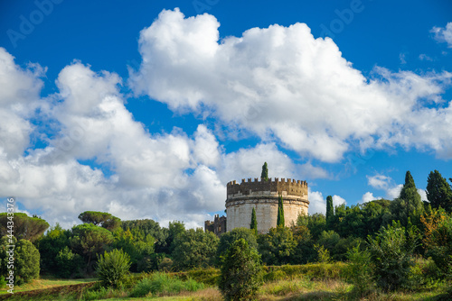 Cecilia Metella, Appia Antica, Rome. Beautiful panorama of the mausoleum with clouds and blue sky. Today the Appia Museum which collects statues, sarcophagi, inscriptions, reliefs, funerary monuments.