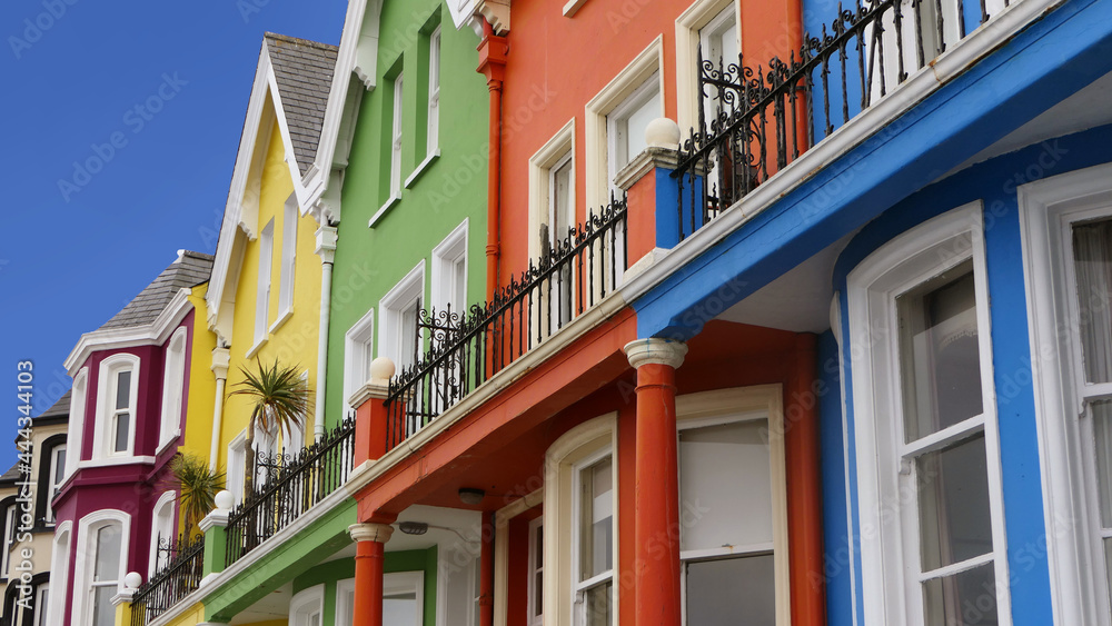 Yellow Red Orange Green Blue sky houses by the sea Whitehead N. Ireland Yellow Red Orange Green Blue sky houses by the sea Whitehead N. Ireland
