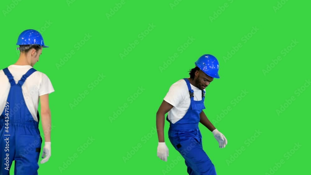 Construction workers switch places while carrying a hand-barrow on a Green Screen, Chroma Key. Construction workers switch places while carrying a hand-barrow on a Green Screen, Chroma Key.