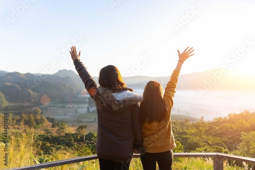Lifestyle traveler women happy feeling good relax and freedom facing in the sunrise morning. Travel Concept