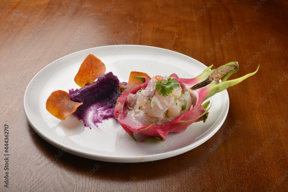 cold pink dragon fruit salad with root paste appetiser on wood table fine dining western menu cold pink dragon fruit salad with root paste appetiser on wood table fine dining western menu