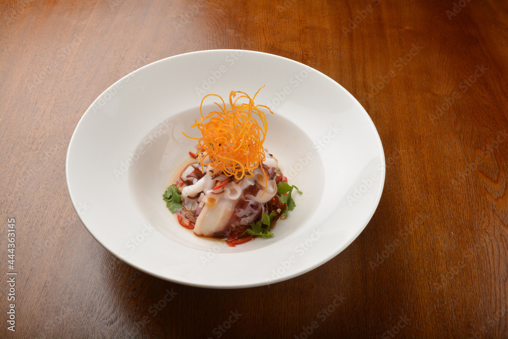 cold dish octopus sashimi salad with green vegetables and carrot appetiser on wood table fine dining western menu