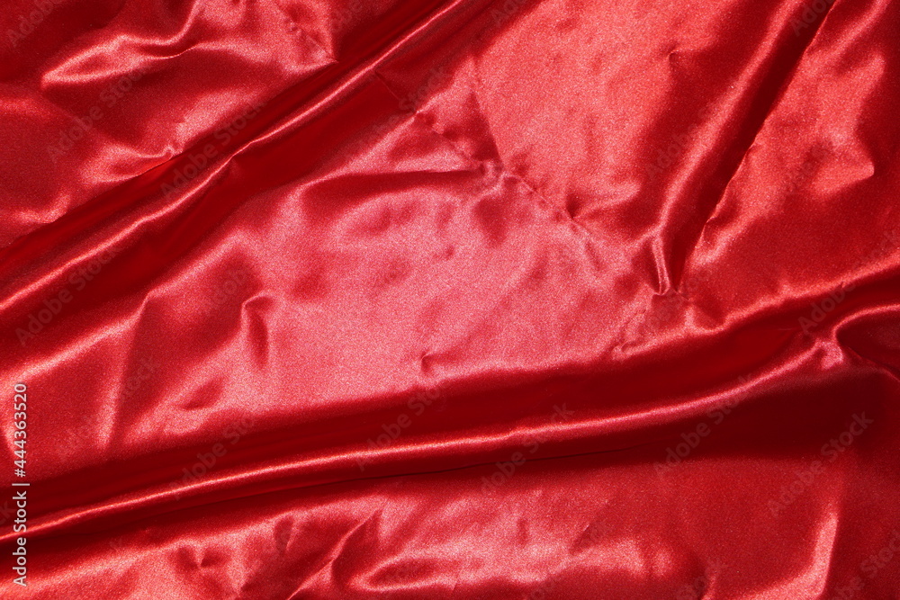 Smooth elegant red silk or satin luxury cloth texture can use as wedding background. Luxurious background design    