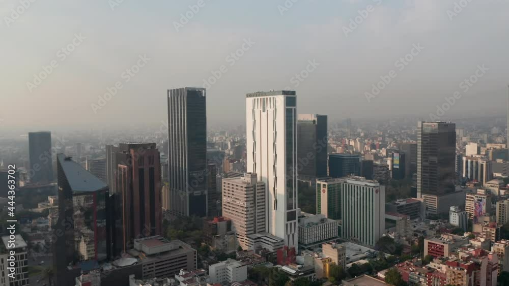 Panorama curve shot of downtown. Flying towards tall office buildings. Limited visibility due to air pollution. Mexico City, Mexico. Panorama curve shot of downtown. Flying towards tall office buildings. Limited visibility due to air pollution. Mexico City, Mexico.