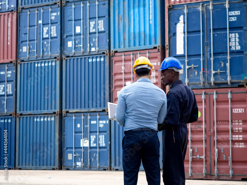 Foreman engineer african black skin talk look report businessman manager male notebook computer laptop tablet terminal warehouse technology shipper port logistic commercial container forklift custom