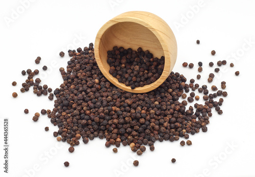 black pepper in a wooden bowl isolated on white background