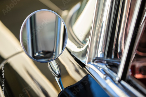 Detail of chrome side mirror on 1960 Old Sport Sedan