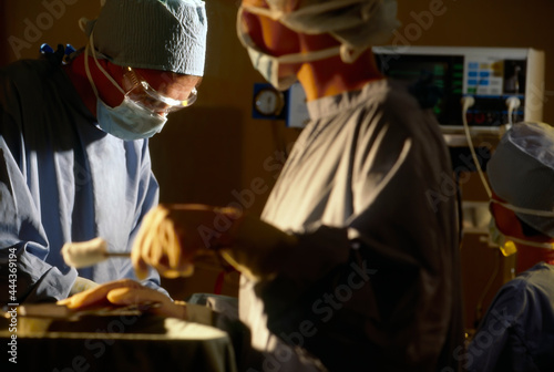 Nurses assisting doctor in theatre of hospital with operation