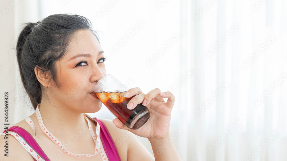 Portrait beautiful plump young Asian woman joy of eating drinking cola , Sweet water , sparkling water on bedroom reason why you are fat - lifestyle Woman diet weight loss overweigh Portrait beautiful plump young Asian woman joy of eating drinking cola , Sweet water , sparkling water on bedroom reason why you are fat - lifestyle Woman diet weight loss overweigh